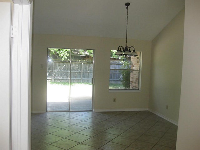 unfurnished dining area with tile patterned flooring, a chandelier, and vaulted ceiling