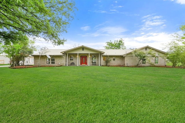 single story home with brick siding and a front yard