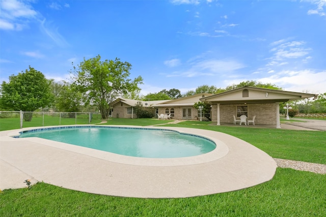 view of swimming pool with a fenced in pool, a lawn, fence, and a patio