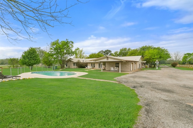 view of yard featuring a patio, fence, and a fenced in pool