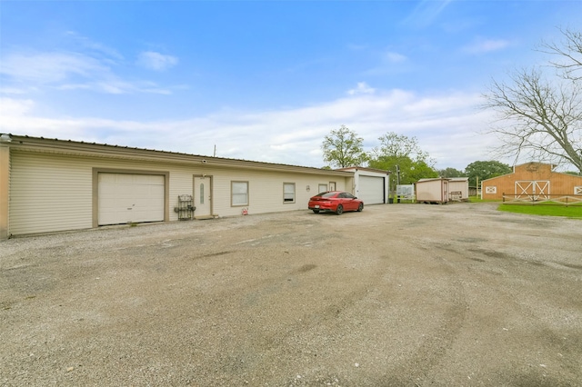 view of front facade featuring an outdoor structure and a detached garage