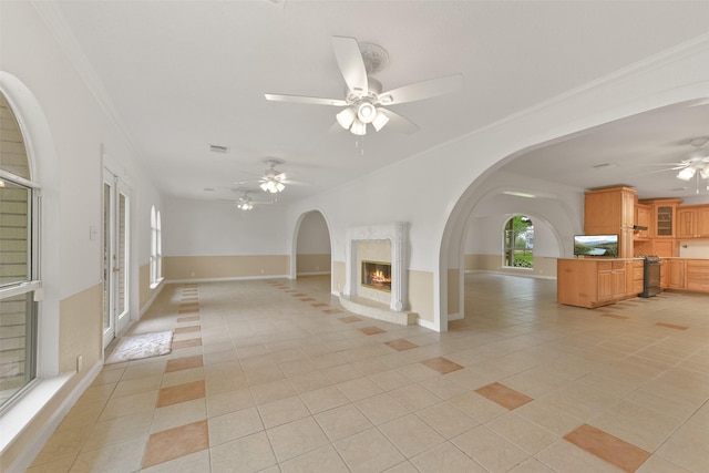 spare room with light tile patterned floors, ornamental molding, and a high end fireplace