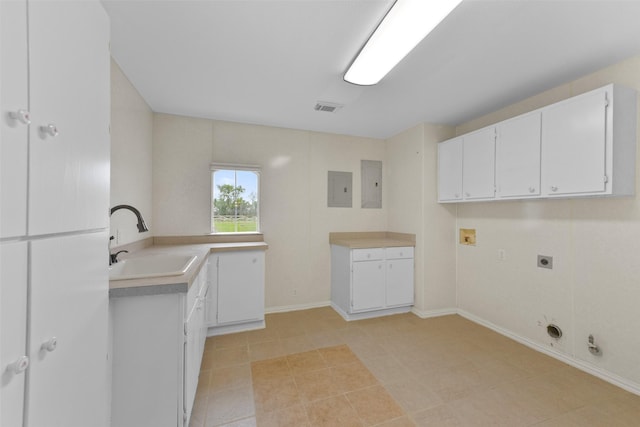 laundry area featuring cabinet space, visible vents, hookup for a gas dryer, a sink, and electric dryer hookup