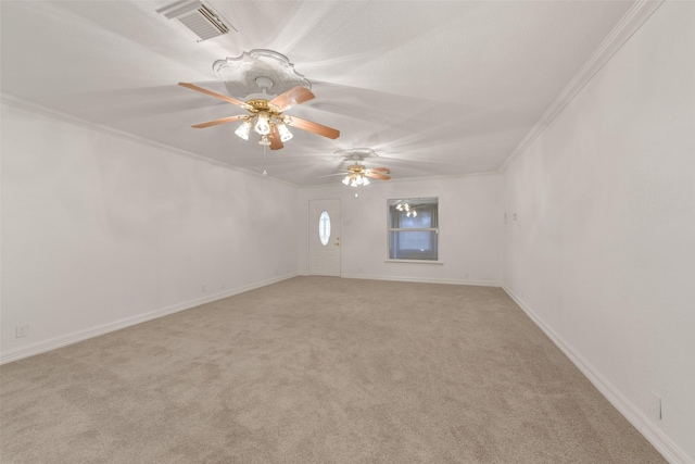 empty room featuring crown molding, visible vents, a ceiling fan, light carpet, and baseboards