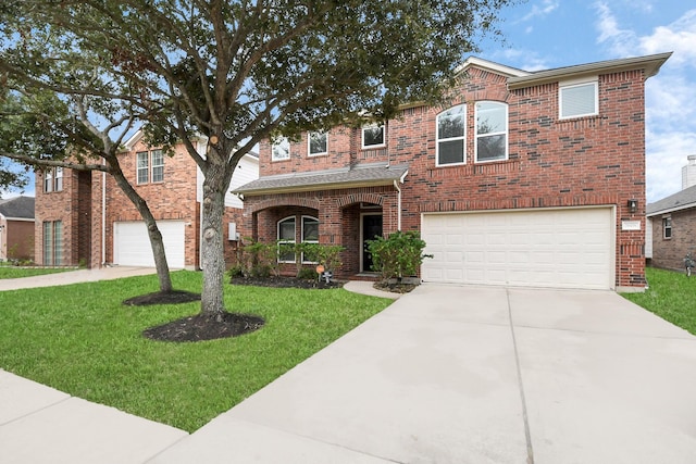 view of front of house with a front yard and a garage