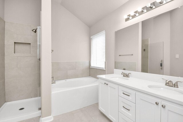 bathroom with tile patterned flooring, vanity, separate shower and tub, and lofted ceiling