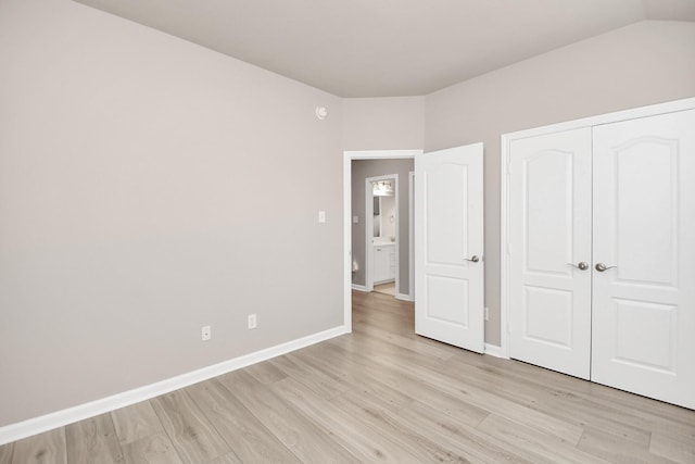 unfurnished bedroom featuring a closet and light wood-type flooring