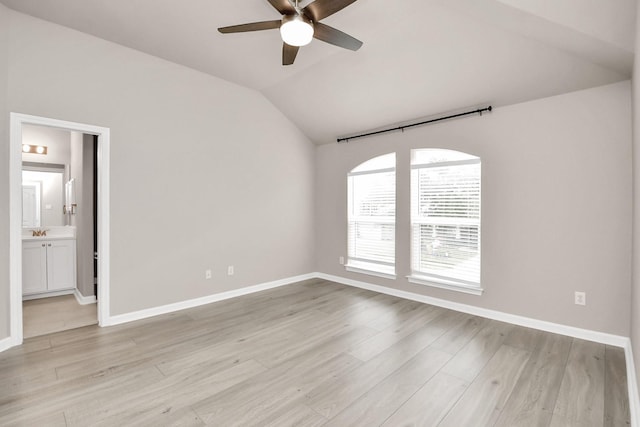 spare room featuring ceiling fan, sink, light hardwood / wood-style flooring, and vaulted ceiling