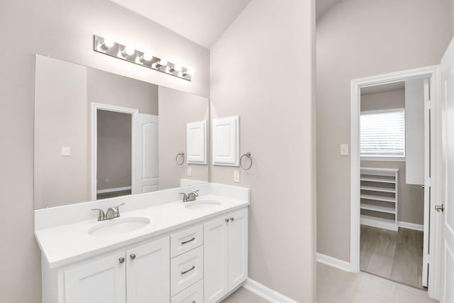 bathroom with vanity, tile patterned floors, and lofted ceiling