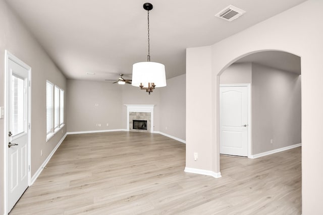 unfurnished living room with a fireplace, light hardwood / wood-style floors, and ceiling fan