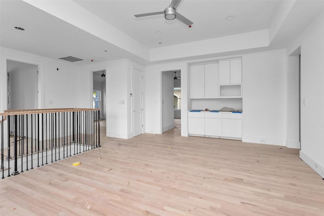 unfurnished living room featuring ceiling fan and light hardwood / wood-style flooring