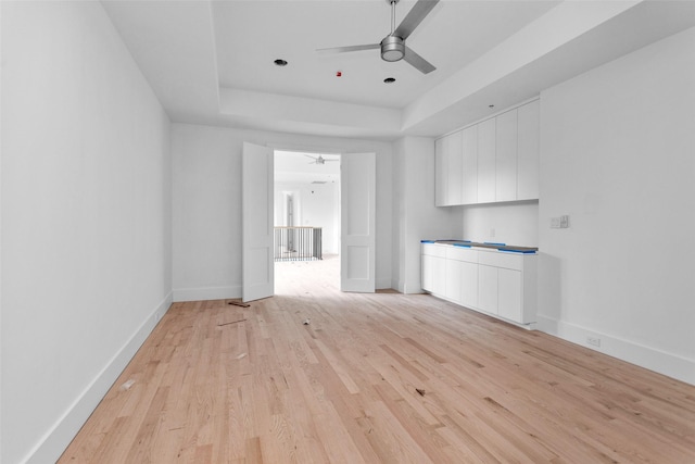 unfurnished living room featuring ceiling fan and light wood-type flooring