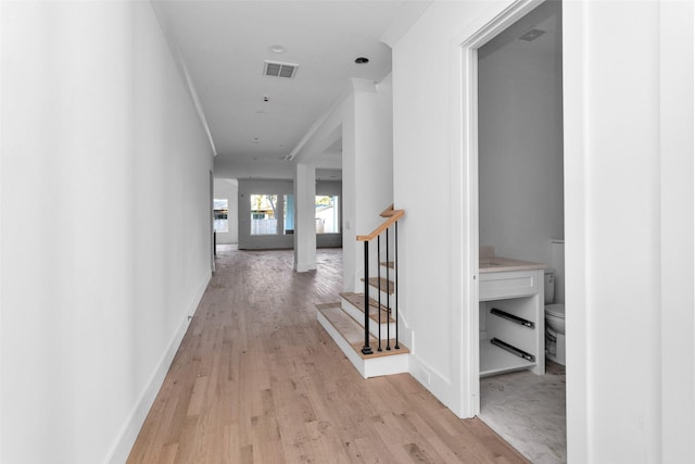 corridor with light hardwood / wood-style floors