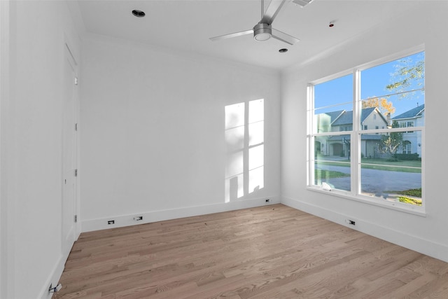 spare room with plenty of natural light, ceiling fan, ornamental molding, and light hardwood / wood-style flooring