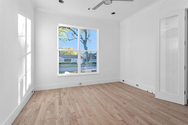 empty room featuring ceiling fan, light hardwood / wood-style floors, and ornamental molding