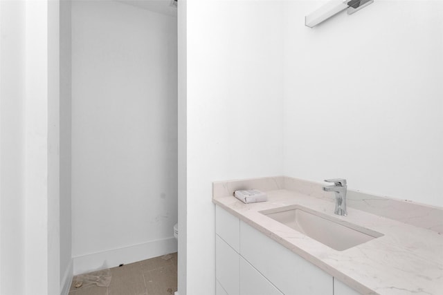 bathroom featuring tile patterned flooring, vanity, and toilet