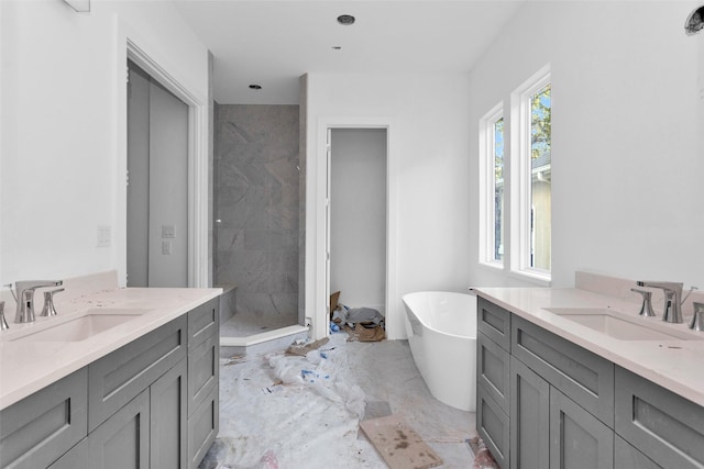 bathroom featuring plus walk in shower and vanity