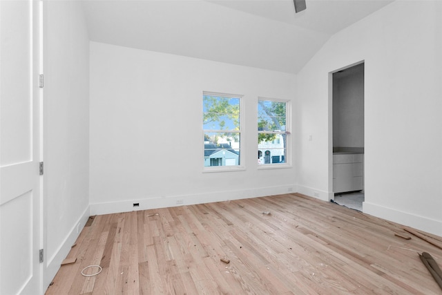 unfurnished bedroom with ceiling fan, light hardwood / wood-style floors, and vaulted ceiling