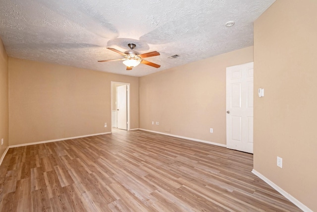 empty room with ceiling fan, a textured ceiling, and light wood-type flooring