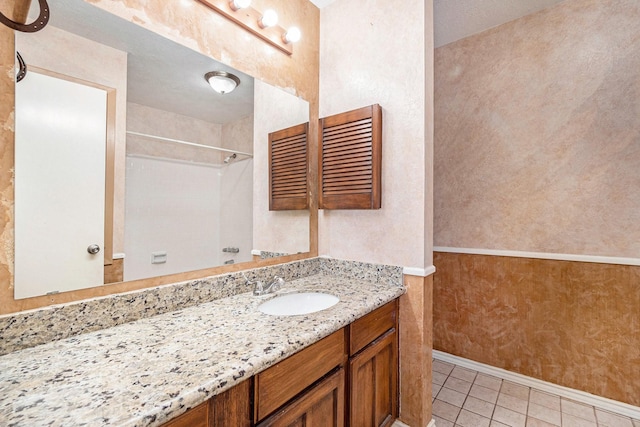 bathroom with a textured ceiling, vanity, and tile patterned floors