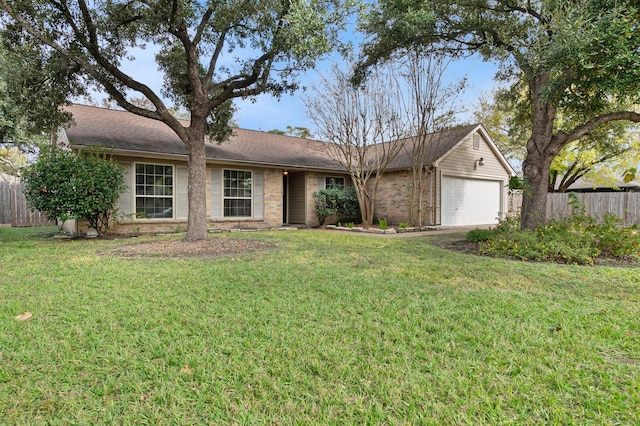 single story home featuring a garage and a front yard