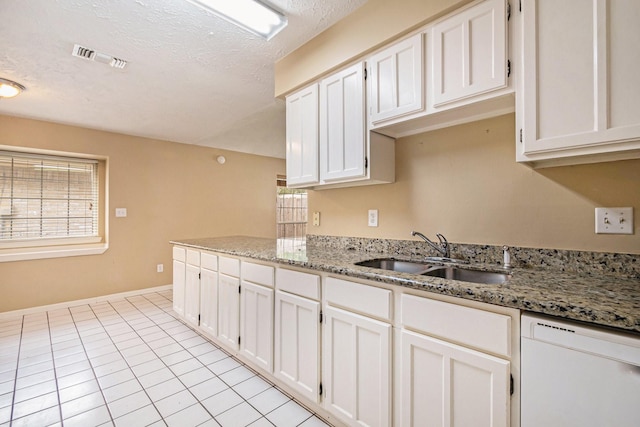 kitchen featuring light stone countertops, dishwasher, white cabinets, and sink