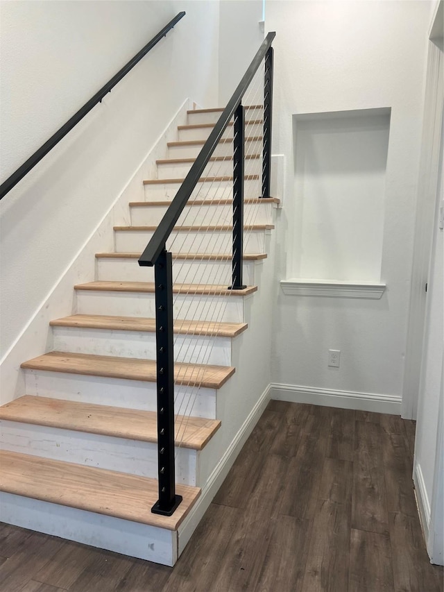 staircase with hardwood / wood-style flooring