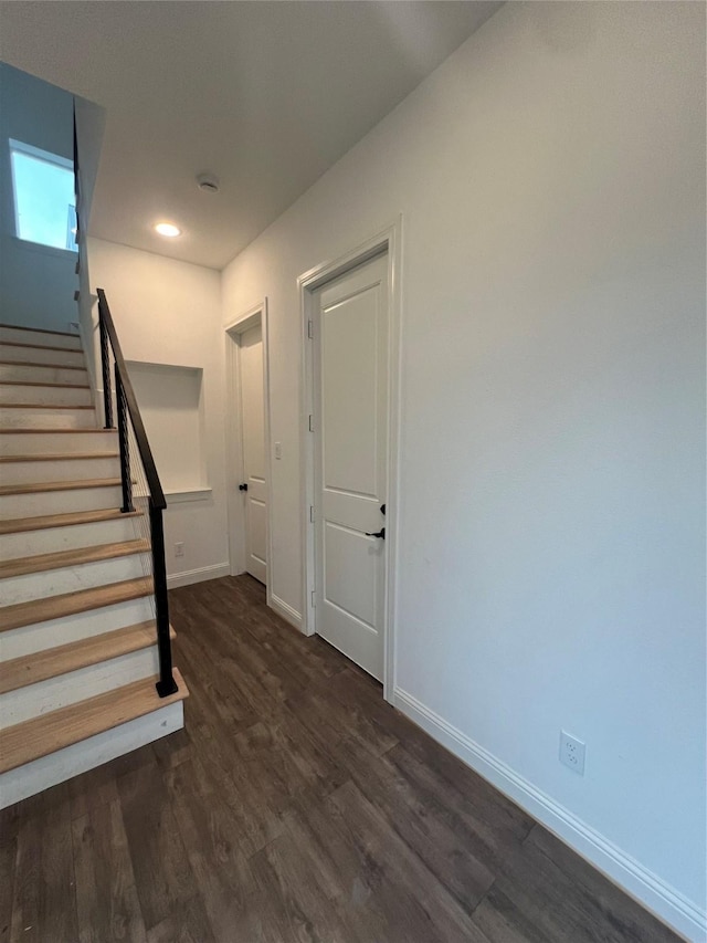 stairway featuring wood-type flooring