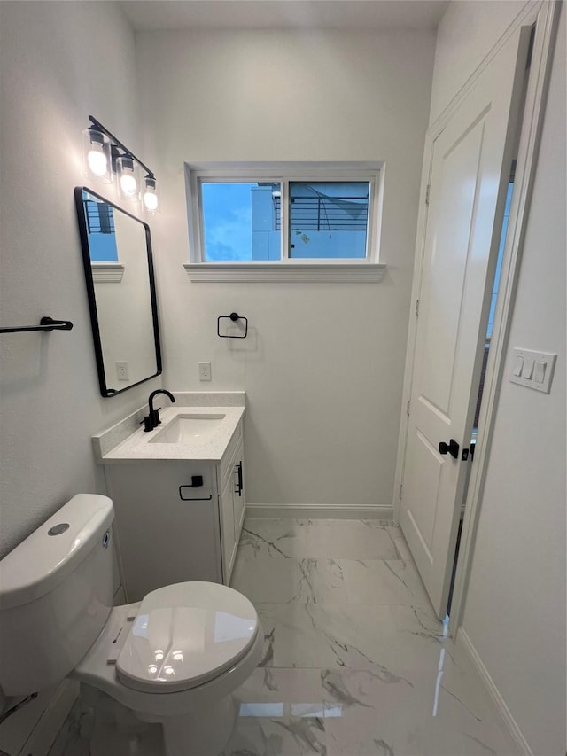 bathroom featuring vanity and toilet