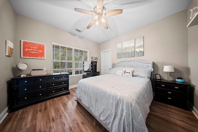 bedroom with ceiling fan and dark hardwood / wood-style floors