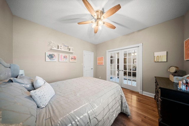 bedroom featuring ceiling fan, dark wood-type flooring, access to outside, and french doors