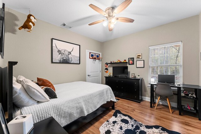 bedroom with ceiling fan and light hardwood / wood-style floors