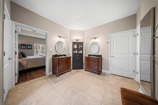 bathroom with tile patterned flooring and vanity