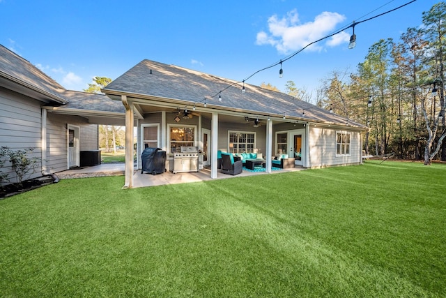 back of house with a lawn, outdoor lounge area, ceiling fan, and a patio area