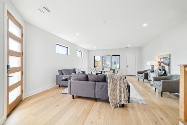 living room featuring recessed lighting, baseboards, visible vents, and light wood finished floors