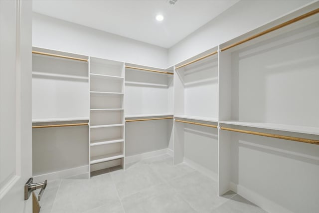 spacious closet with light tile patterned floors