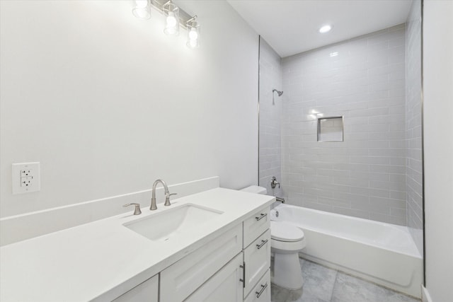 bathroom featuring washtub / shower combination, vanity, and toilet