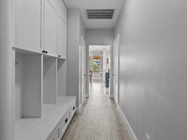 mudroom with light hardwood / wood-style flooring