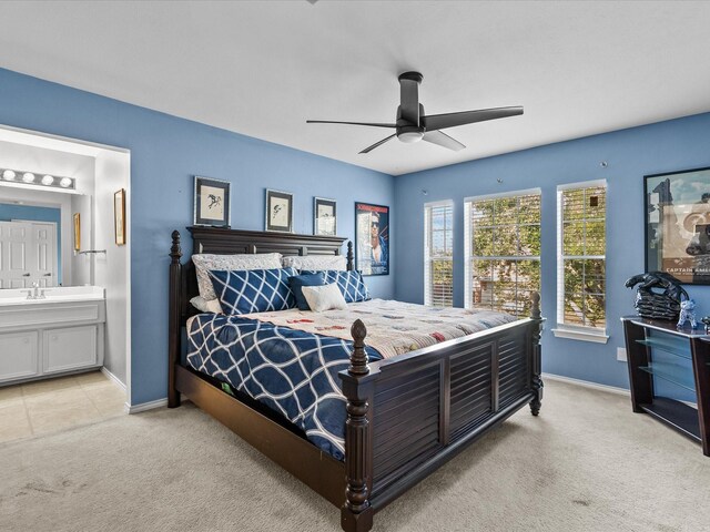 carpeted bedroom featuring ensuite bathroom and ceiling fan