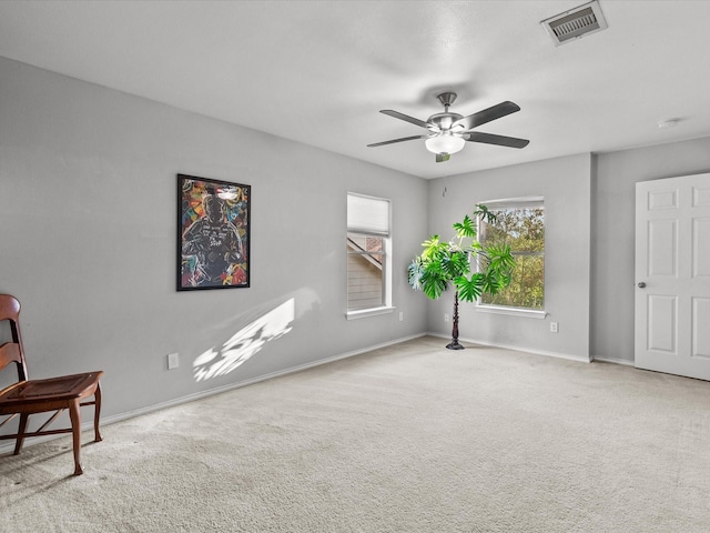 living area with carpet flooring and ceiling fan