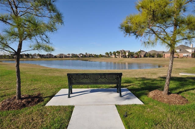 surrounding community featuring a yard and a water view