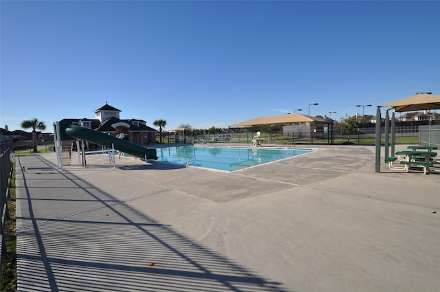 view of swimming pool with a water slide