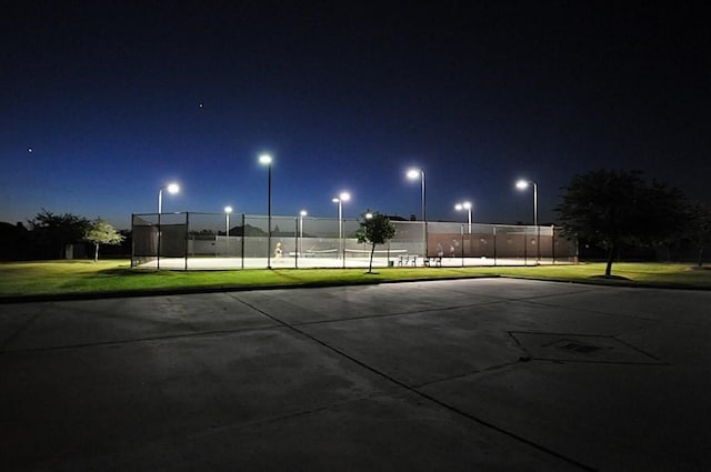 view of community with a lawn and tennis court