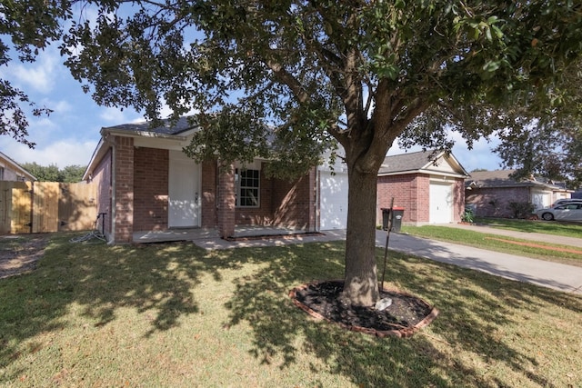 ranch-style home featuring a front yard and a garage