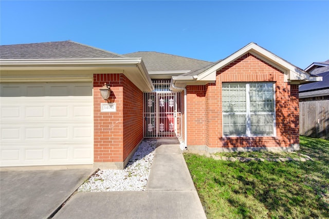 view of exterior entry featuring a garage and a yard