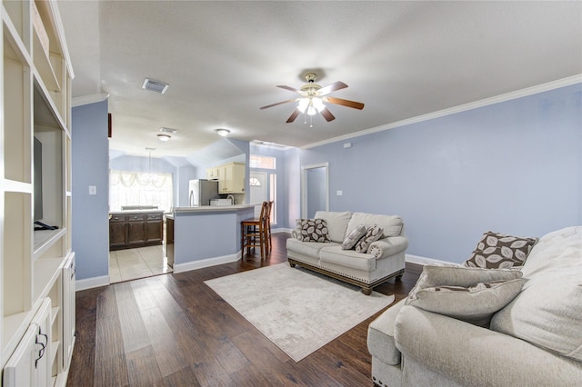 living room featuring dark hardwood / wood-style flooring, ceiling fan, and crown molding