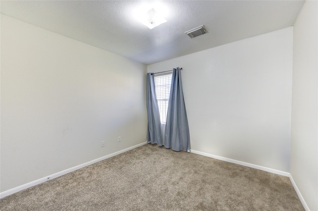 empty room featuring carpet floors and a textured ceiling