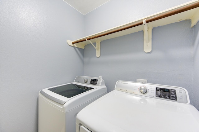 laundry room featuring washing machine and clothes dryer