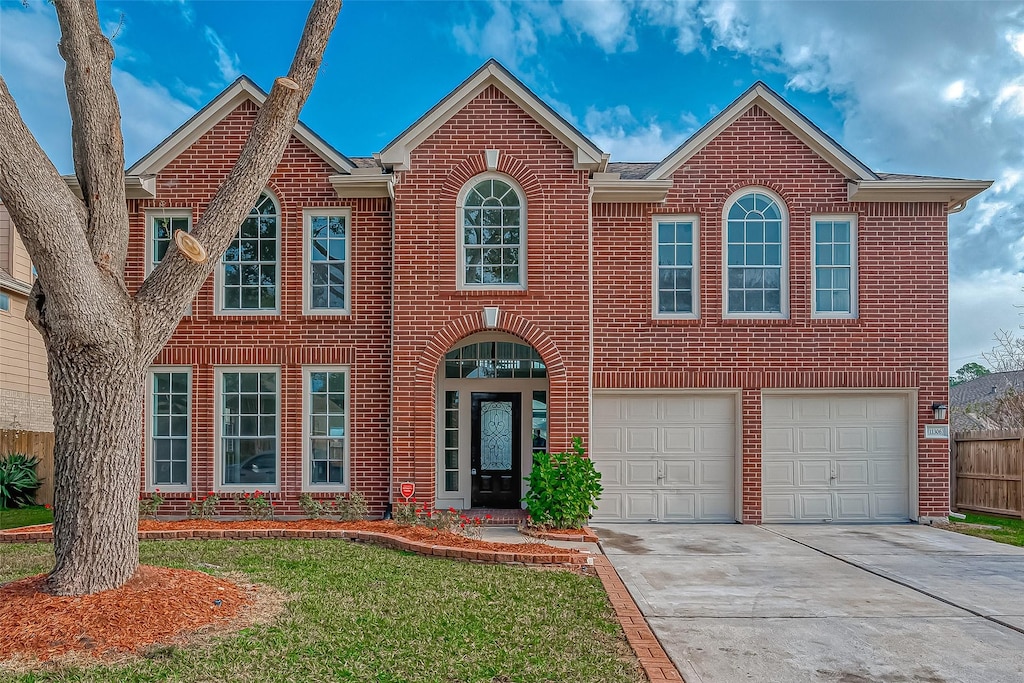 view of front of home featuring a garage and a front lawn