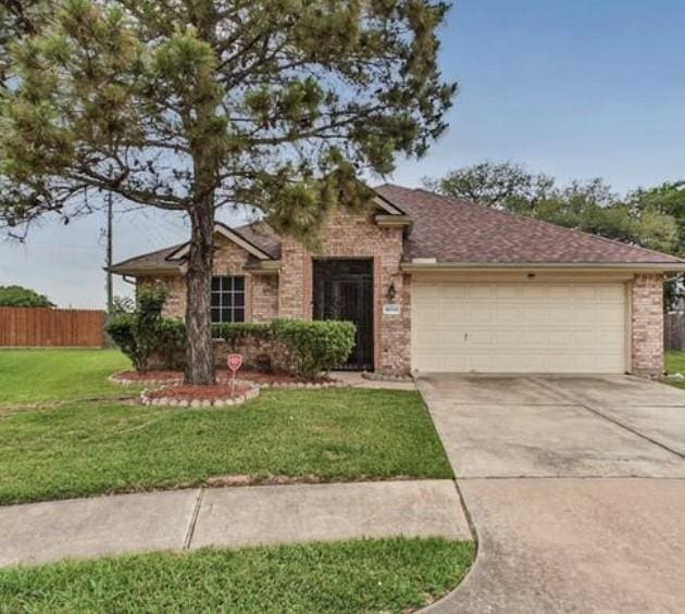 single story home with a front lawn and a garage